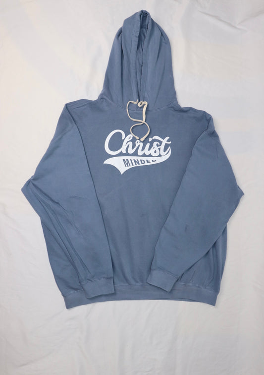 Blue “Christ Minded” hoodie with white lettering and cream drawstrings laid flat on a white background.