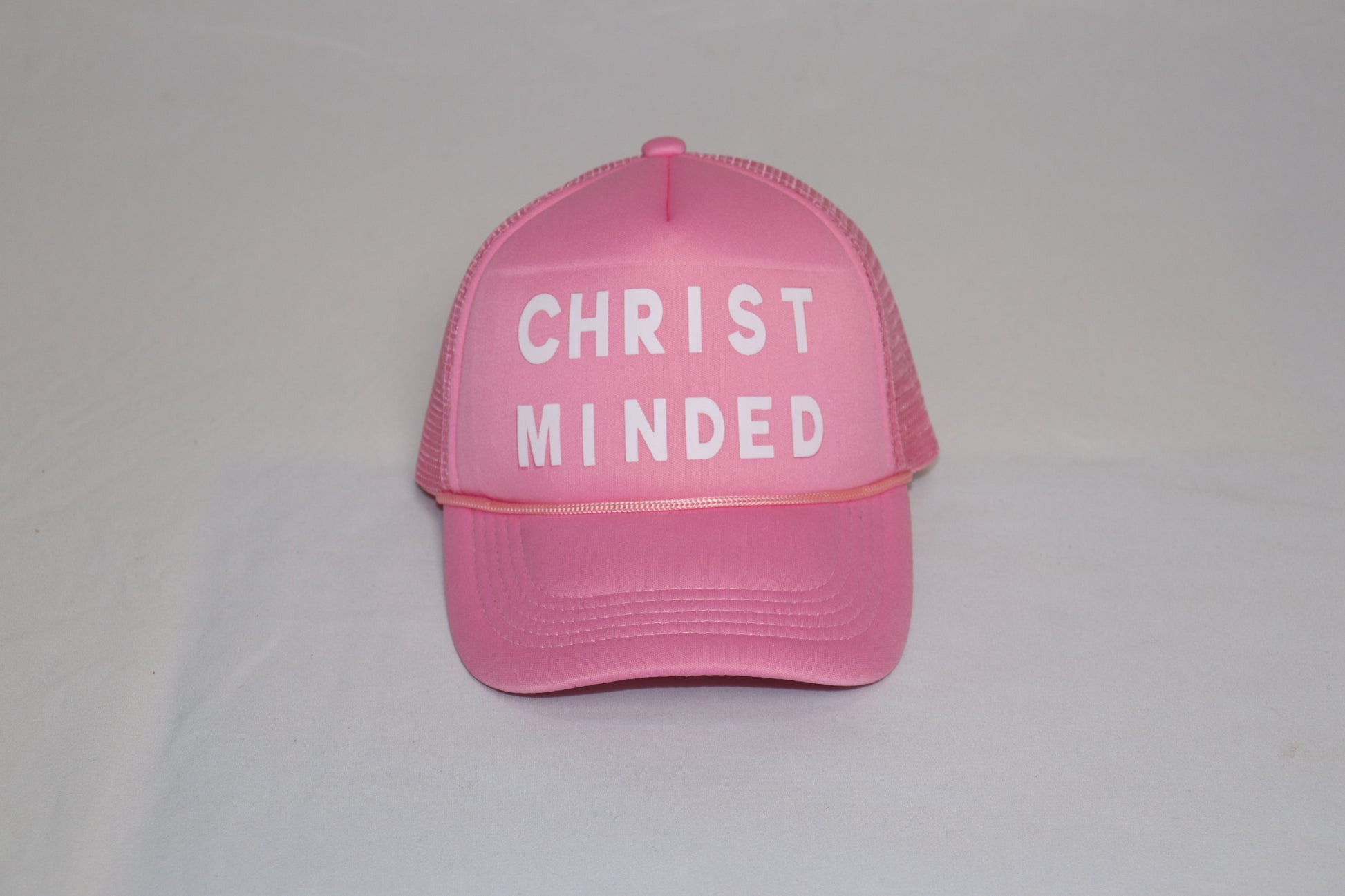 Pink Christian trucker hat with bold white “Christ Minded” lettering, symbolizing grace and renewal.