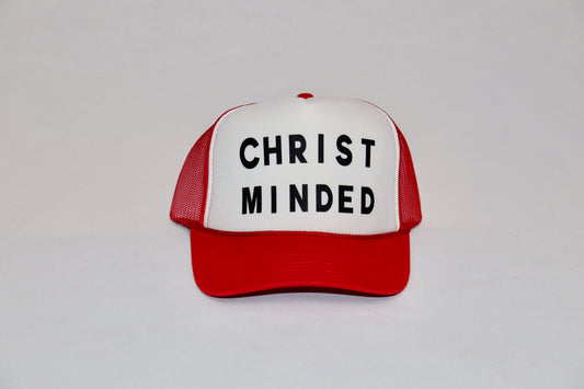Red and white Christ Minded trucker hat with bold black lettering on front panel